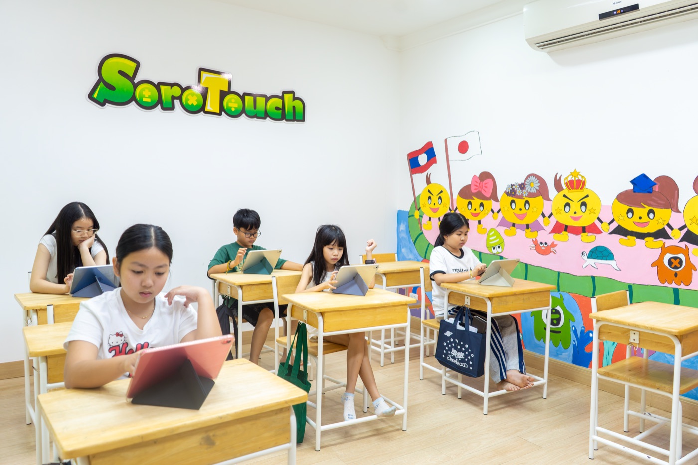 ນັກຮຽນ SoroTouch Laos ຝຶກຜ່ານ tablet ໃນຫ້ອງຮຽນ